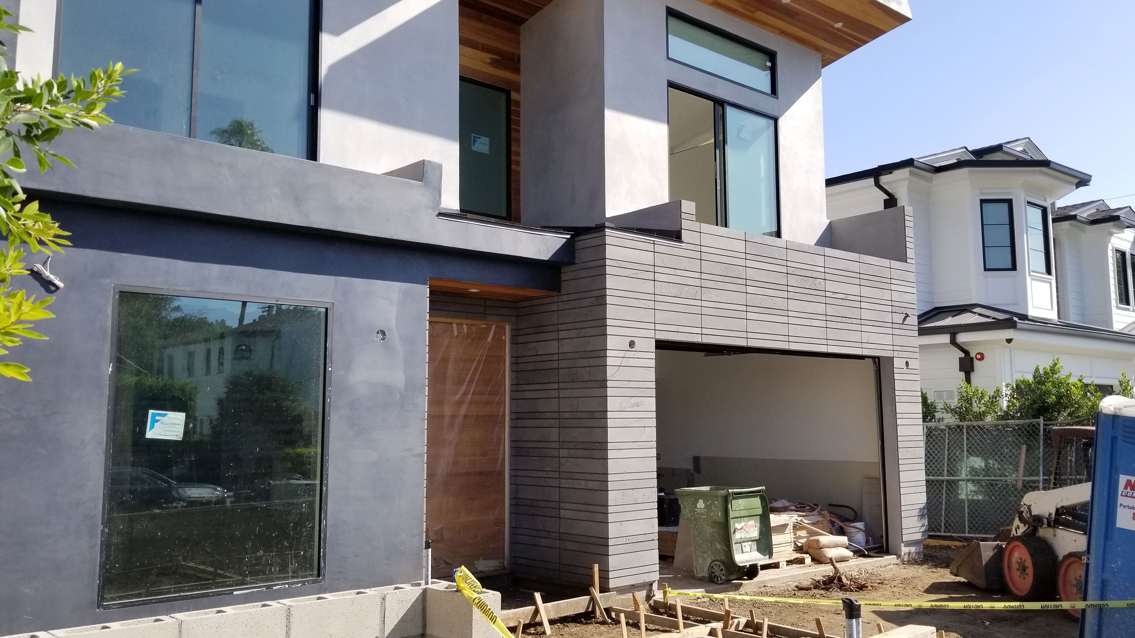 Norstone Platinum Planc Large Format Tile used as an accent on the front facade of a modern home under construction in Hollywood, CA